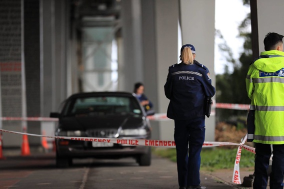 Police have taped a significant area under the Auckland Harbour Bridge next to a Northcote Point property where a woman died on Sunday. Photo / Hayden Woodward