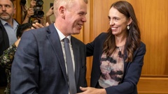 Outgoing Prime Minister Jacinda Ardern congratulates new Labour Party leader Chris Hipkins on their way to the caucus room. Photo / Mark Mitchell