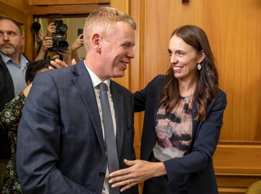 Outgoing Prime Minister Jacinda Ardern congratulates new Labour Party leader Chris Hipkins on their way to the caucus room. Photo / Mark Mitchell