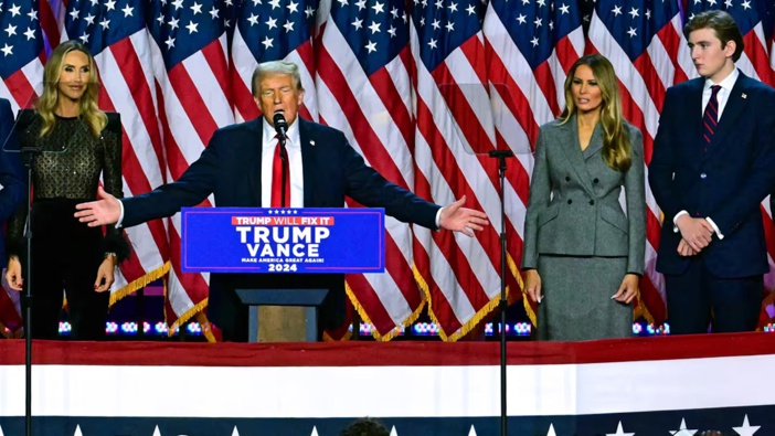 Donald Trump has claimed victory in the US election, flanked by wife Melania and son Barron. Photo / AFP