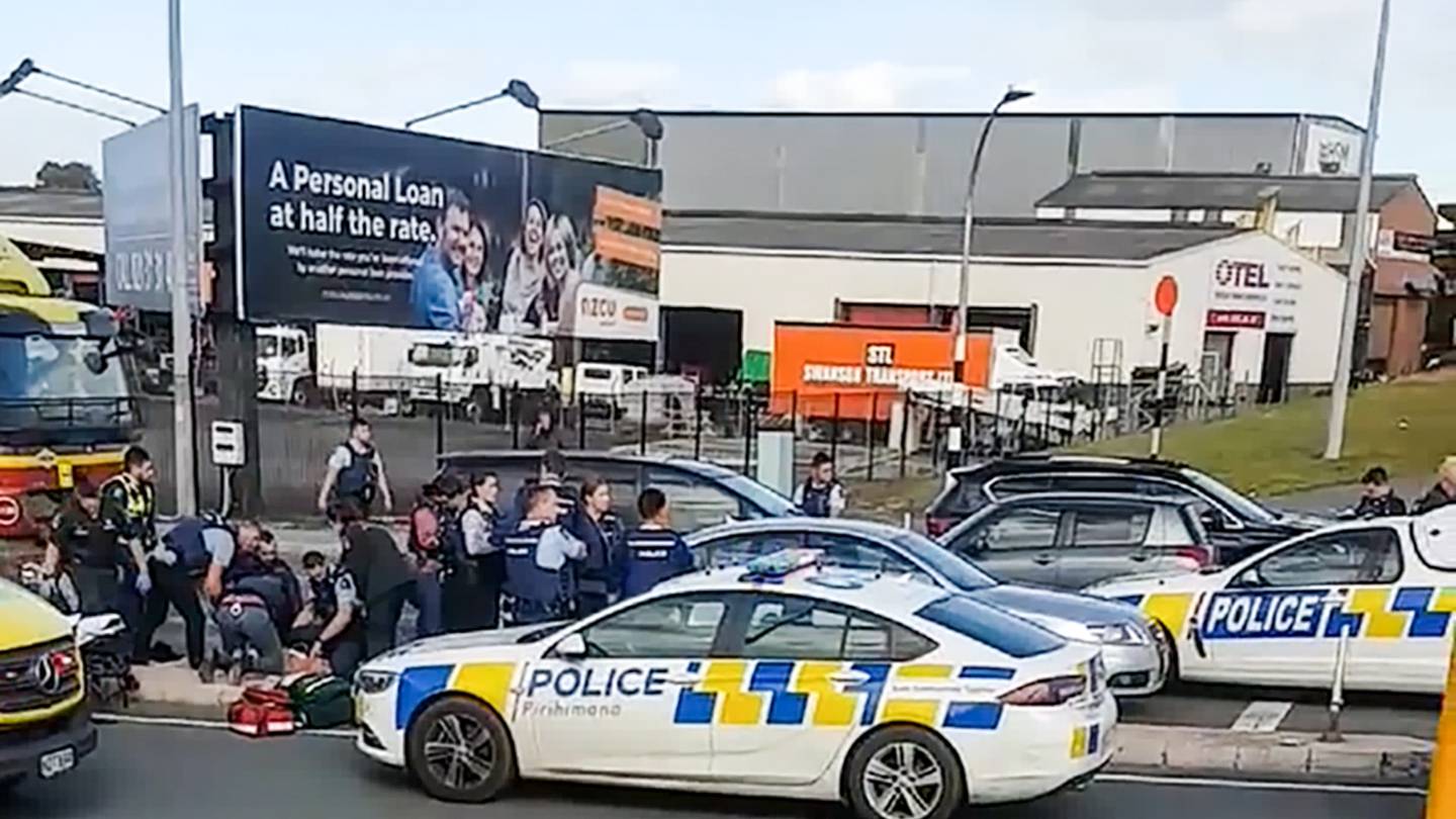 Police and ambulance treating a man who was shot by police yesterday. Photo / Supplied