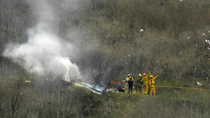 Firefighters work the scene of a helicopter crash where former NBA basketball star Kobe Bryant and his daughter died in Calabasas in 2020. Photo / AP