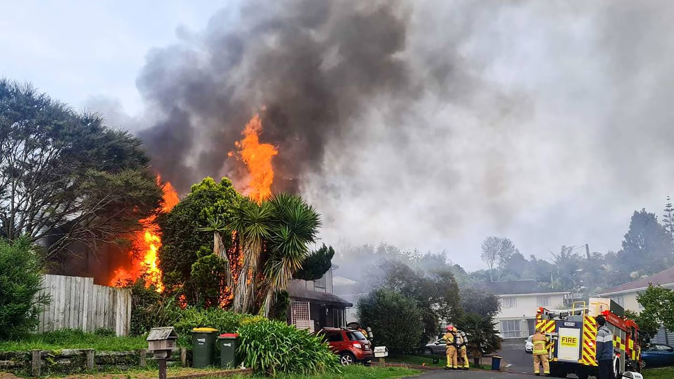 Firefighters fighting the house fire on Kohekohe Street in New Lynn. Photo / Supplied