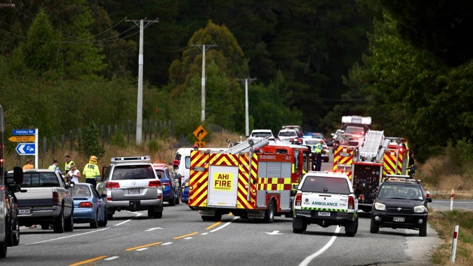Emergency services respond to a crash on State Highway 6 near Wānaka. Photo / George Heard