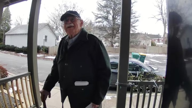 Doug Turner delivering an invitation for his winter party to his neighbour, Michelle Hernandez, in Bucks County, Pennsylvania. Photo / Michelle Hernandez