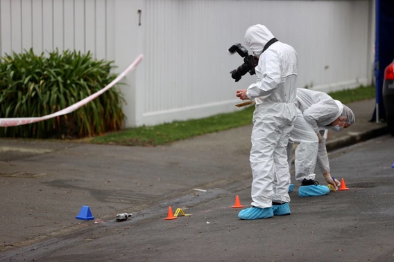 Police forensic experts at the scene of the murder last month. (Photo / George Heard)