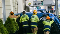 A rescue crew from Hastings works to right the car that overturned in the CBD soon after midday on Sunday. Photo / Paul Taylor