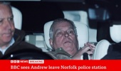 Andrew Mountbatten-Windsor leaves the police station in a photograph by Reuters being used during the BBC live coverage.
