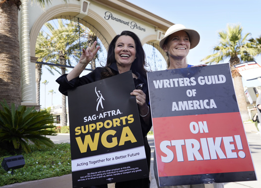 Fran Drescher, left, president of SAG-AFTRA, and Meredith Stiehm, president of Writers Guild of America West, pose together during a rally by striking writers outside Paramount Pictures studio in Los Angeles on May 8, 2023. Photo / AP