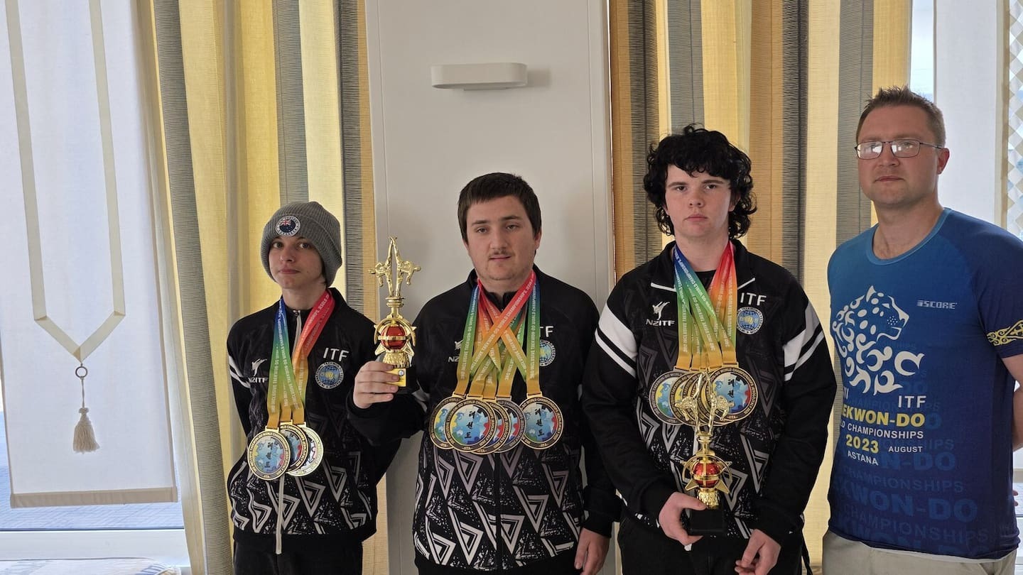 Three Hawke’s Bay athletes William Thomas, left, Jacob Cunningham and Coby O'Neil won 12 medals, including 10 gold, at the Inclusive Taekwon-Do World Championships in Italy. They are with coach Ben Evans.