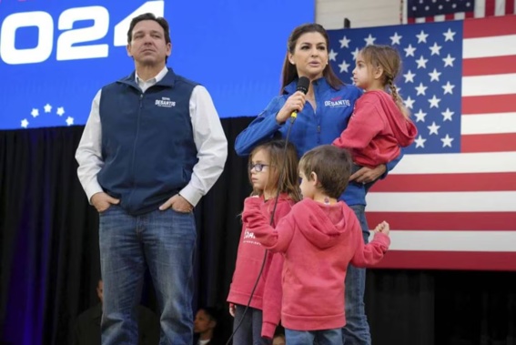 Republican presidential candidate Florida Governor Ron DeSantis, left, looks on as his wife Casey, holding daughter Mamie, in front Madison, left, and Mason. Photo / AP