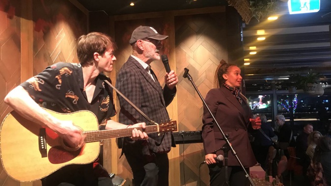 Auckland Mayor Wayne Brown singing his Phil Goff song at the end of the celebrity debate on Tuesday, with singer Megan Alatini at right. Photo / Simon Wilson