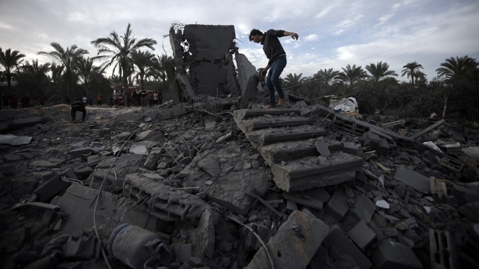 Palestinians inspect the damage of a destroyed house following Israeli airstrikes in the town of Khan Younis, southern Gaza Strip, Wednesday, Nov. 22, 2023. Photo / AP