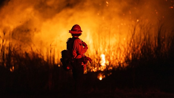 US officials warned "dangerous and strong" winds were set to push deadly wildfires further through Los Angeles residential areas as firefighters struggled to make progress against the flames. Photo / AFP