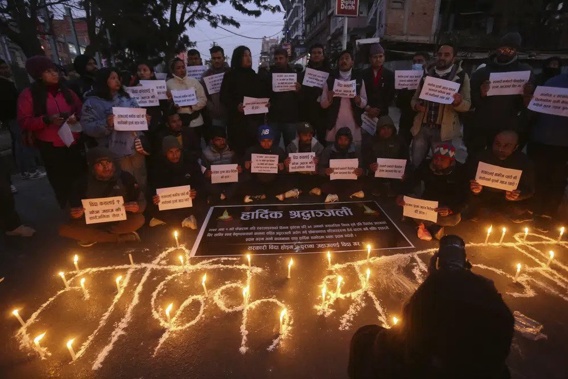 People observe a candlelight vigil in memory of victims of a plane crash in Kathmandu, Nepal, Monday, Jan. 16, 2023. The Yeti Airlines flight from Kathmandu that plummeted into a gorge Sunday killed at least 70 passengers out of the 72 on board. (AP Photo/Bikram Rai)