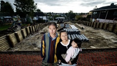 May Qiu and husband Hulin Young say they've lost privacy after the developers behind their property chopped down a 4m high hedge that separated their garden from the building site. Photo / Dean Purcell