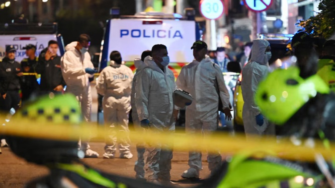 Forensic experts work at the crime scene in the Modelia neighborhood in Bogota where Senator Miguel Uribe was reportedly shot and wounded. Photo / AFP