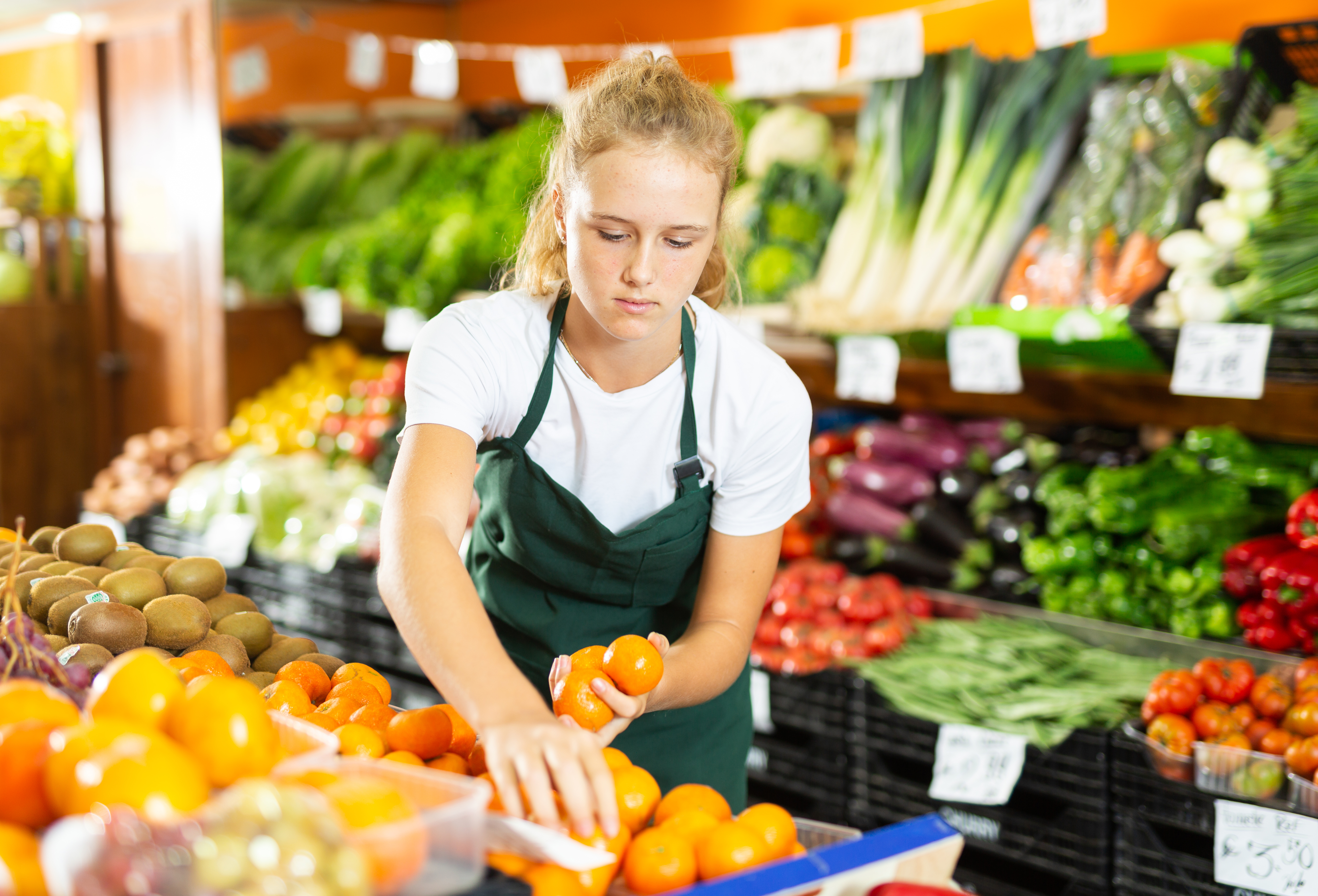 Teenager Working in supermarket / Getty