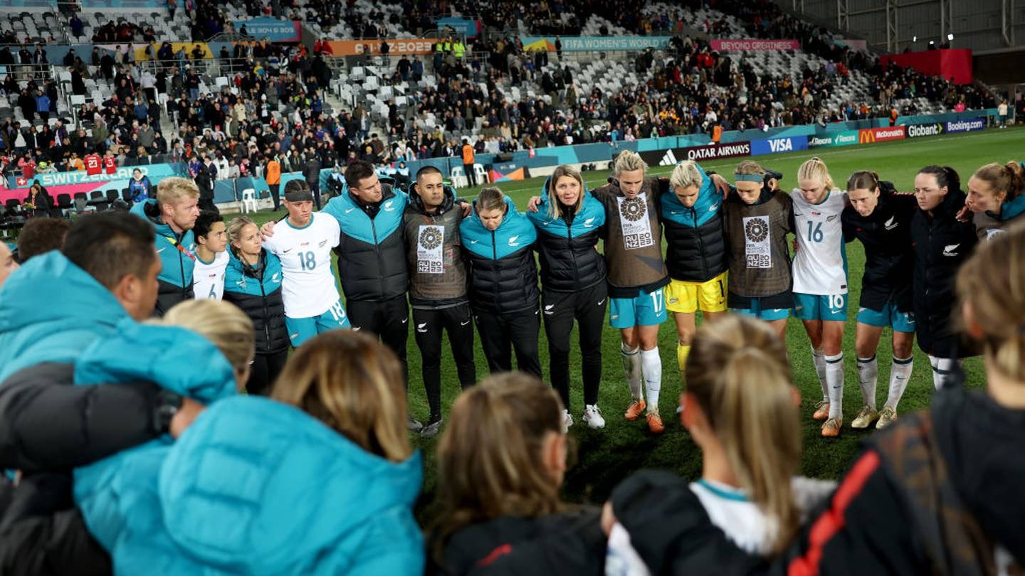 New Zealand players and staff huddle after their final World Cup group game against Switzerland. Photo / Getty Images