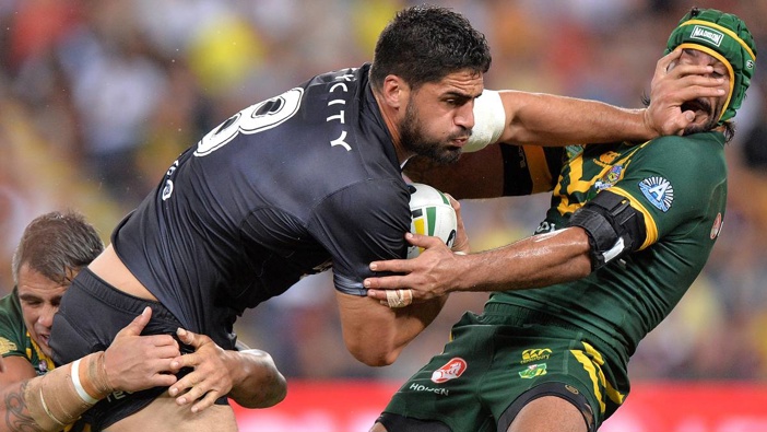 Jesse Bromwich applies a strong fend to the face of Johnathan Thurston. Photo / Getty