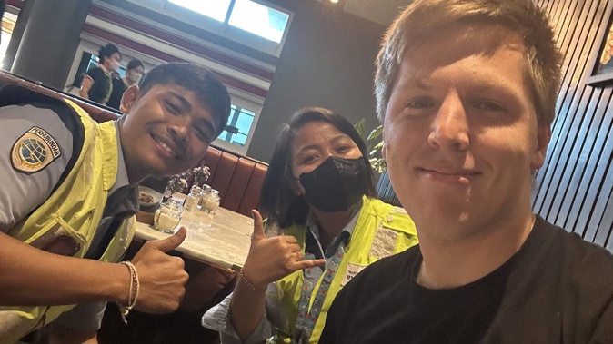 Matt Vandenberg, right, spent 12 hours in Bali Airport with police chaperone. Photo / Matt Vandenberg via Twitter; M1D3V