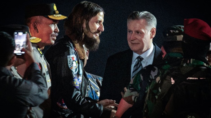 New Zealand pilot Phillip Mehrtens walks with New Zealand Ambassador to Indonesia Kevin Burnett after arriving from Central Papua by an air force plane at an air base in Jakarta on September 21, 2024. Photo / Supplied