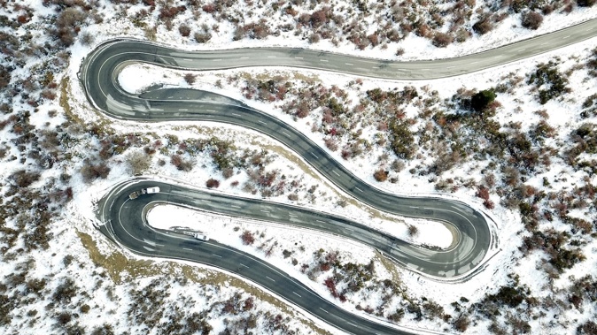 An incoming system is set to deliver widespread wind and rain this week – and a potential heavy dump of snow affecting routes like Crown Range Rd (pictured) – as forecasters issue a raft of severe weather warnings. Photo / George Heard