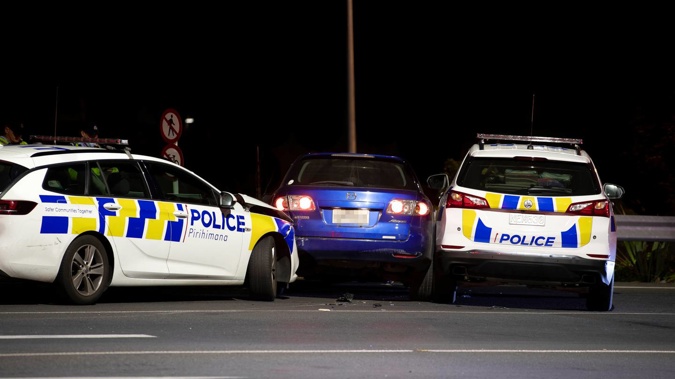 Police stop a blue car thought to be involved in a burglary in Silverdale overnight. (Photo / Hayden Woodward)