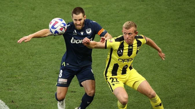 Melbourne Victory’s Josh Brillante (left) and Wellington’s Josh Laws vie for the ball. Photo / Getty Images