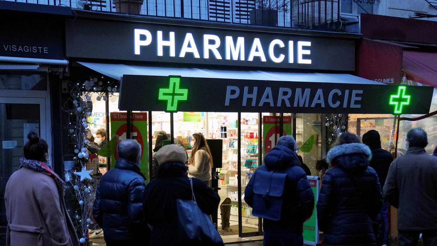 People wait in front of a pharmacy to get a Covid-19 test in Paris, France in January. President Emmanuel Macron has announced France will make condoms free in pharmacies for anyone up to age 25. Photo / AP