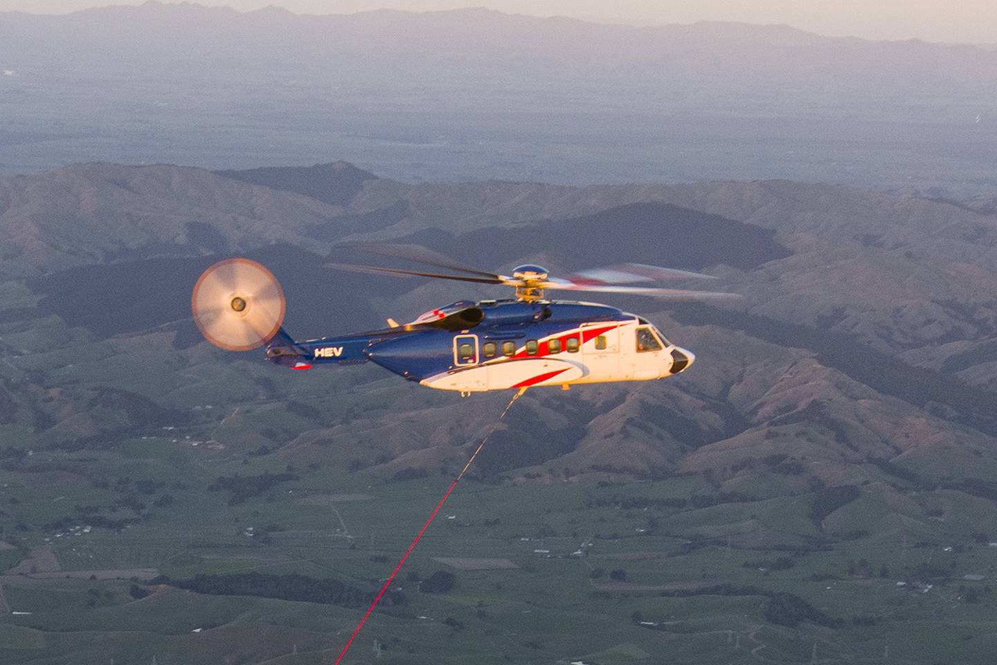 The Sikorsky S-92 helicopter used by Rocket Lab to catch a falling booster is being used for an aid mission. Photo / Supplied