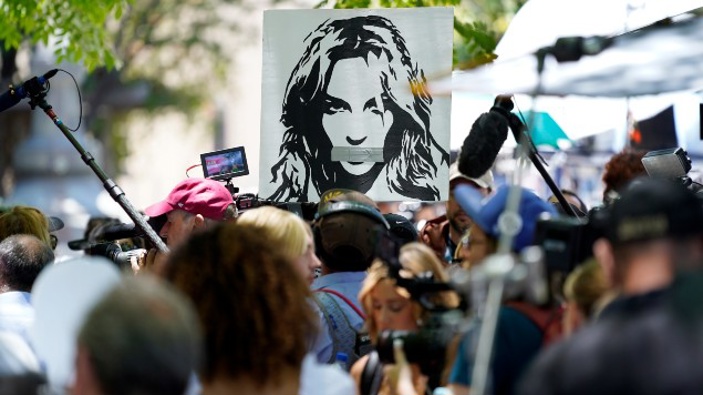 A portrait of Britney Spears looms over supporters and media members outside a court hearing concerning the pop singer's conservatorship. (Photo / AP)