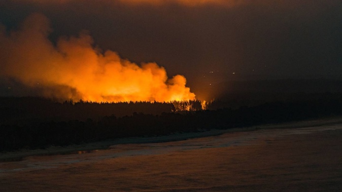Firefighters from various stations across the Bay of Plenty responded to a large vegetation fire on Matakana Island. Photo / Alex Cairns