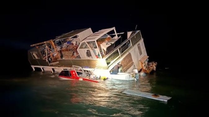A houseboat near Kauwau, north Auckland, flooded during stormy weather. Photo / Kawau Coastguard