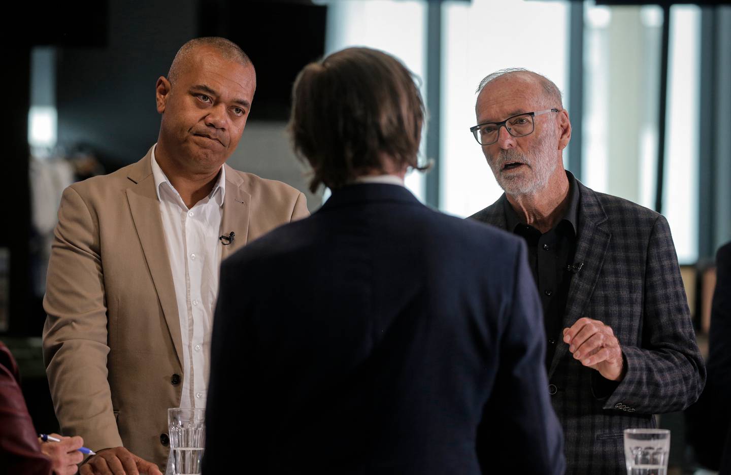 Simon Wilson with mayoral candidates for Auckland, Efeso Collins, left, and Wayne Brown in a debate at the NZ Herald newsroom yesterday. Photo / Alex Burton