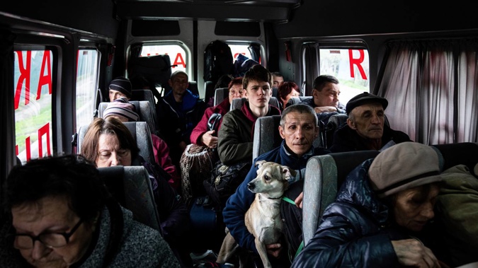 People sit in a bus during evacuation from Lyman, Donetsk region, eastern Ukraine. Photo / AP