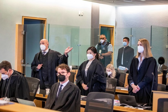 Murder defendant Fang Sun stands in the back of the courtroom as defence lawyers Sam Wimsett, Yvonne Mortimer-Wang and Honor Lanham address the judge. Photo / Michael Craig