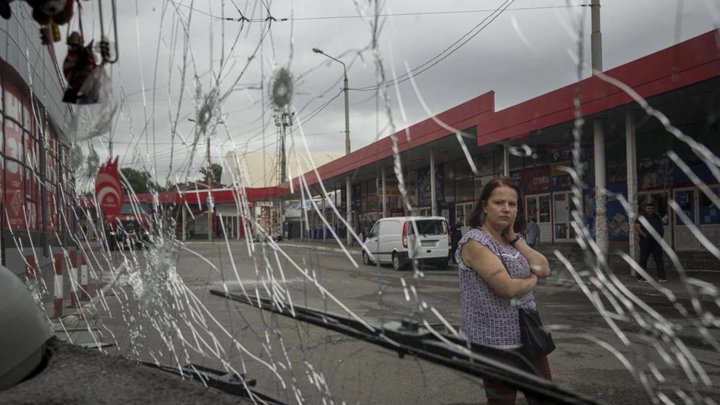 A woman looks at a trolleybus damaged by Russian shelling at Barabashovo market in Kharkiv, Ukraine. Photo / AP