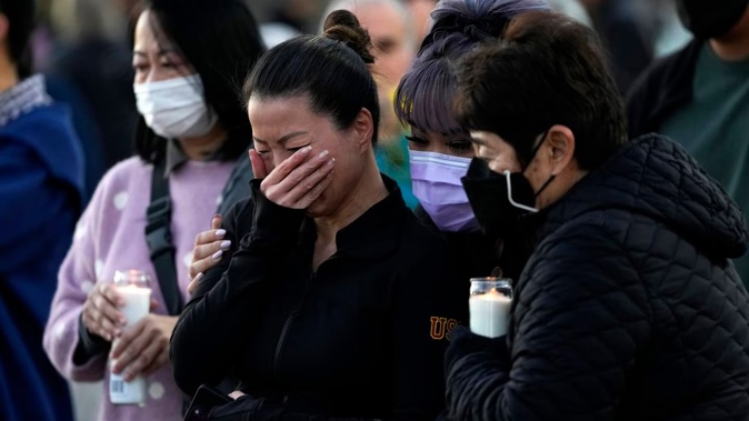 People attend a vigil after the Star Ballroom Dance Studio shooting. Photo / AP