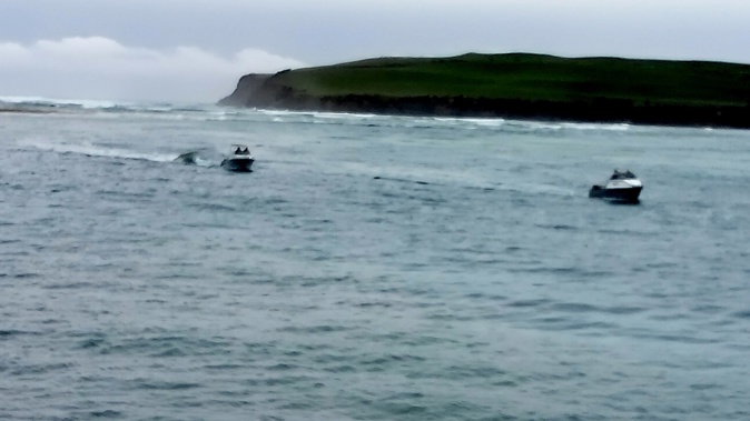 Boats return via the Catlins River Bar after another vessel overturned with one missing and one rescued and taken to hospital on August 17, 2024. Photo / Ester Johnson Surat Bay Lodge