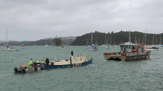 The refloated wreck of the Waitere is towed to Ōpua by the harbourmaster’s vessel, the Waikare, with a dive boat following closely behind. Photo / Peter de Graaf
