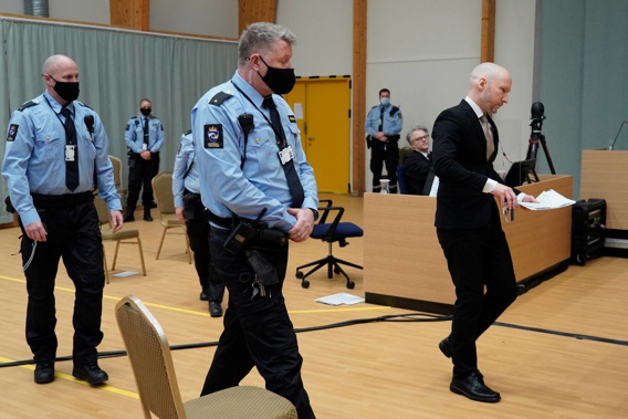 Convicted mass murderer Anders Behring Breivik, right, escorted by police inside a makeshift courtroom on the first day of his parole hearing. (Photo / Ole Berg-Rusten, NTB scanpix via AP)