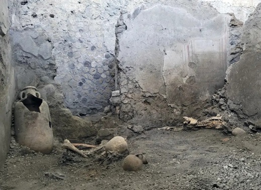 A picture made available Tuesday, May 16, 2023, by the Pompeii Archeological Park press office, showing two skeletons that archeologists believe were men who died when a wall collapsed on them during the powerful earthquakes