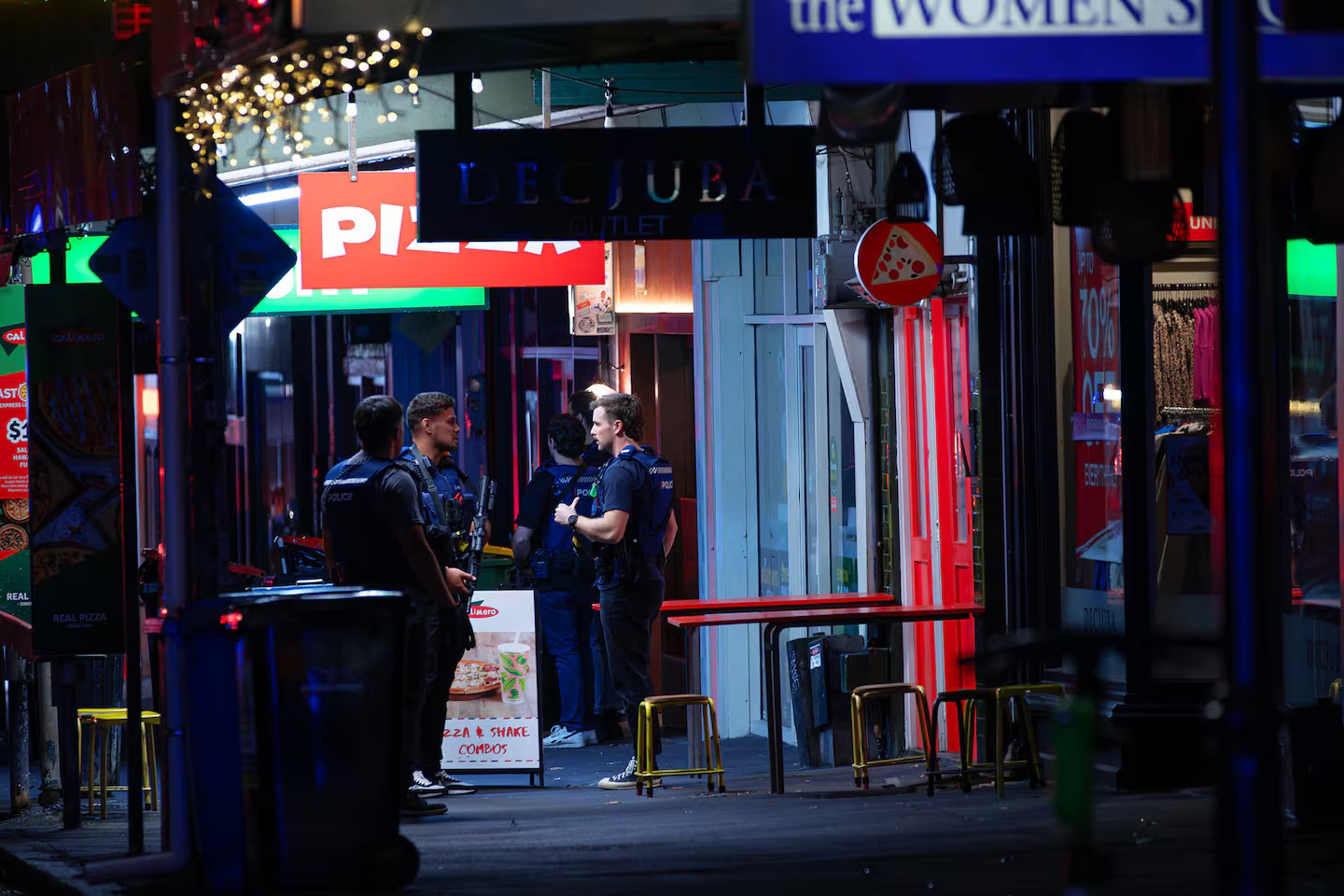 At least two dozen armed police descended on the scene not long after 10.20pm. Photo / Hayden Woodward