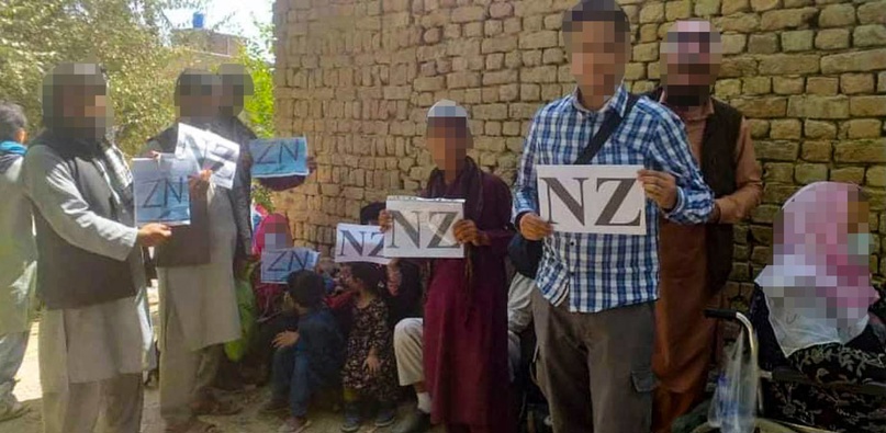 A Group Of New Zealand Visa Holders Held NZ Signs As Part Of Coordinated Efforts With MFAT And The NZDF To Try To Evacuate Them From Kabul's Airport. (Photo / Supplied)