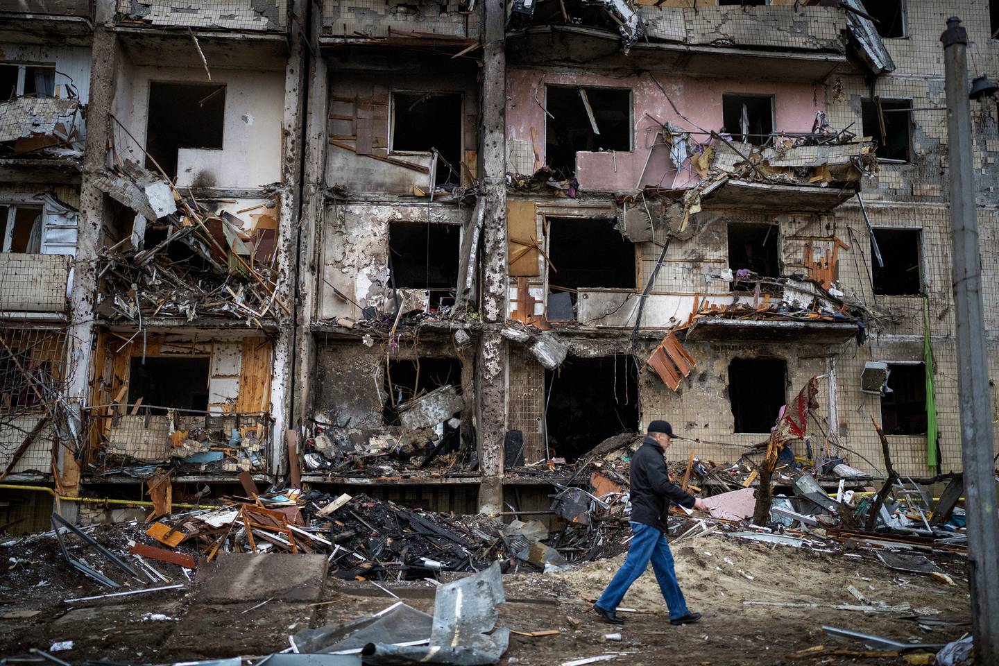 A man walks past a building damaged following a rocket attack, in Kyiv, Ukraine. (Photo / AP)