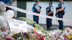 Flowers and candles at the police cordon on Deans Ave in Christchurch after the mosque attacks of 2019. (Photo / Michael Craig)