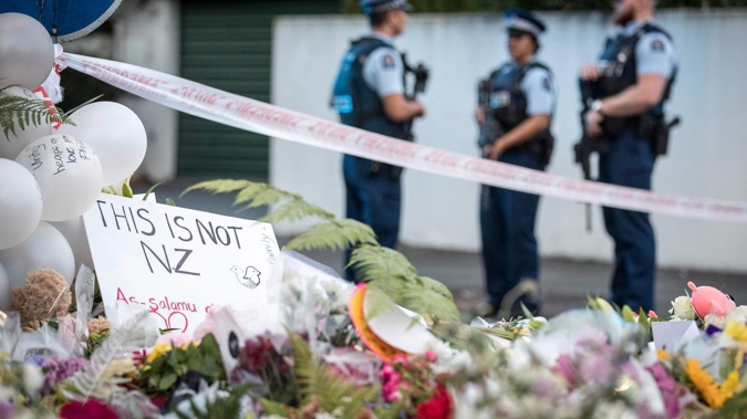 Flowers and candles at the police cordon on Deans Ave in Christchurch after the mosque attacks of 2019. (Photo / Michael Craig)