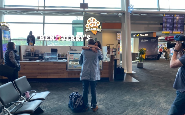 Emotional reunions at Wellington Airport as Aucklanders return. (Photo / Nick James) 