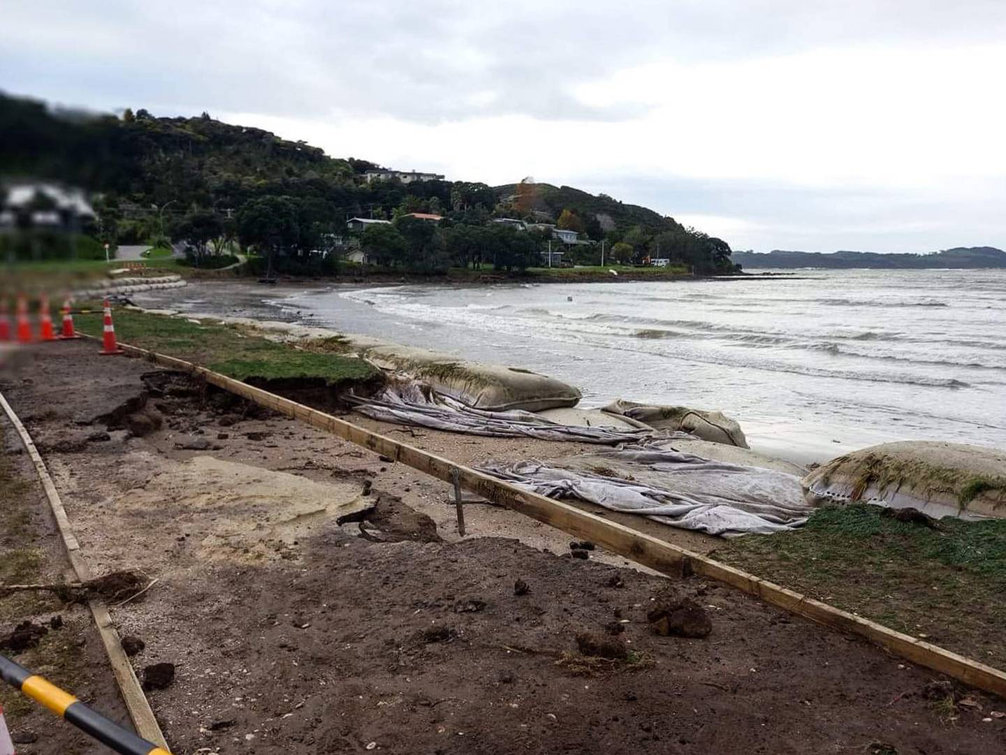 Contractors clean up the foreshore at Brophy's Beach after it was wiped out by large waves. (Photo / Thames District Council)